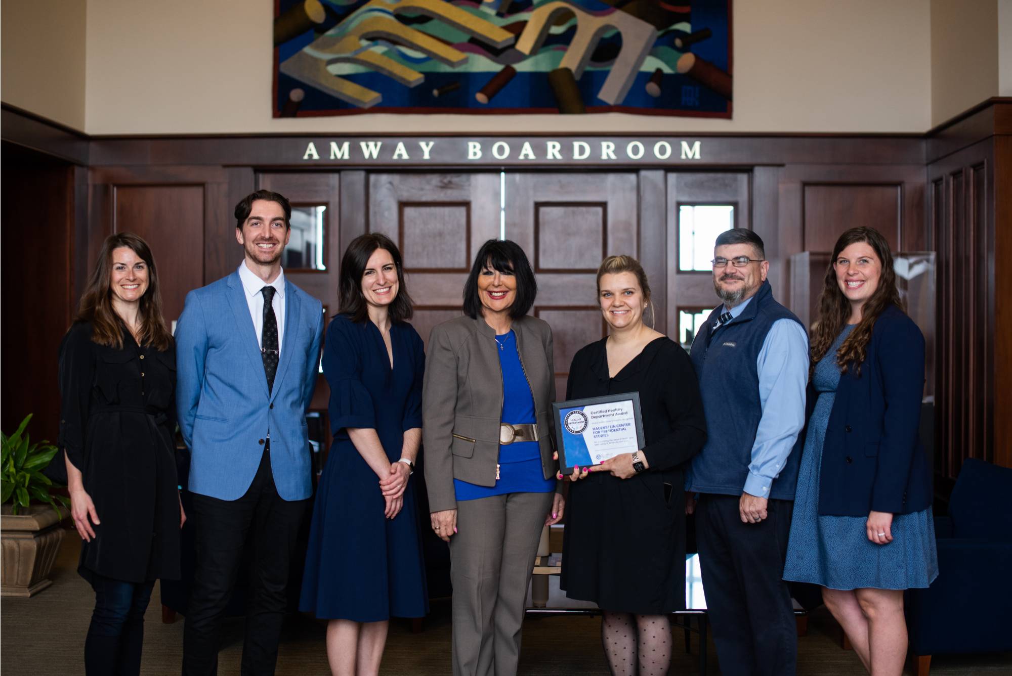 The Hauenstein Center for Presidential Studies team smiling and standing together with President Mantella, holding their certificate for becoming a Certified Healthy Department